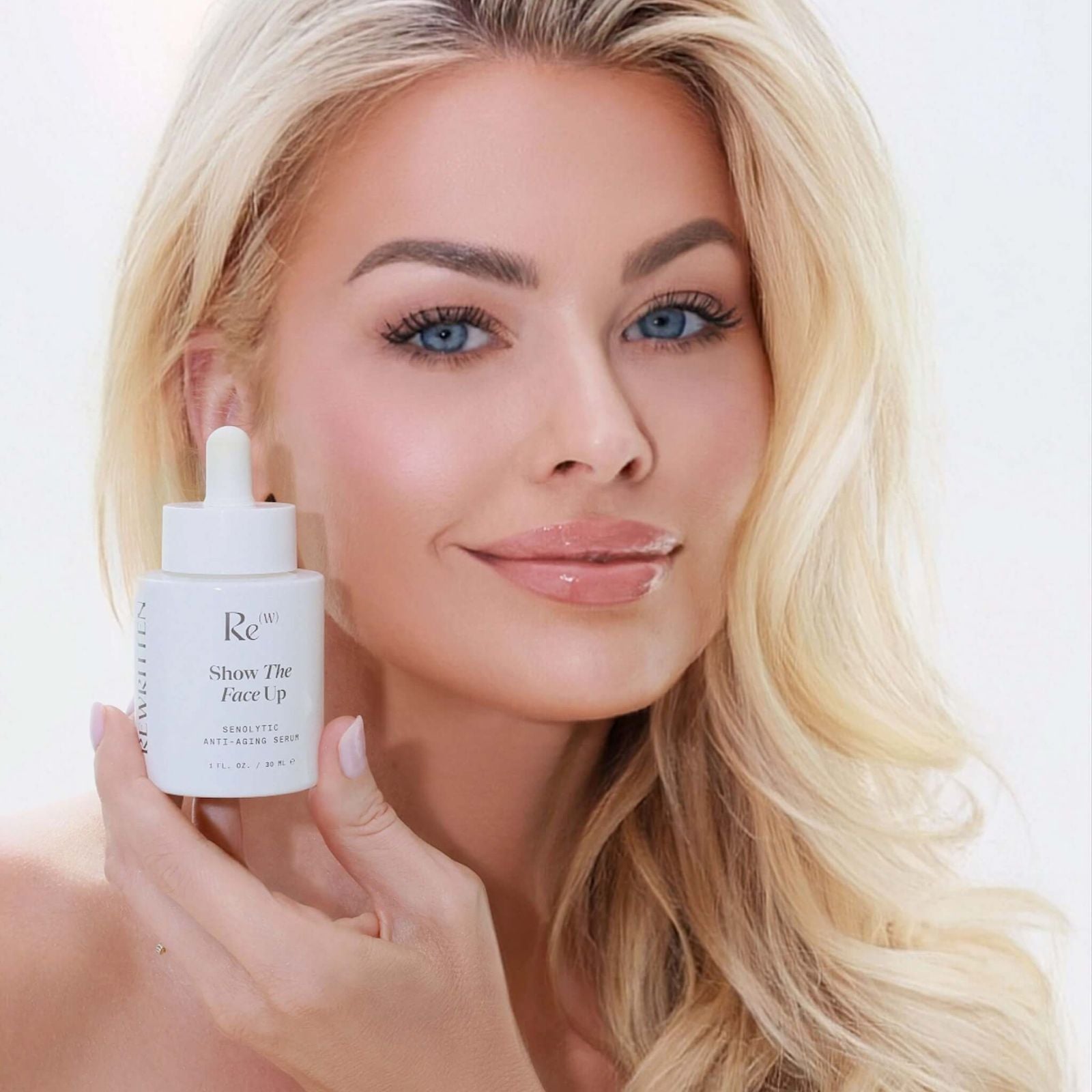 Rewritten Beauty founder Cynthia Garcia holding the Show The Face Up serum bottle close to her face