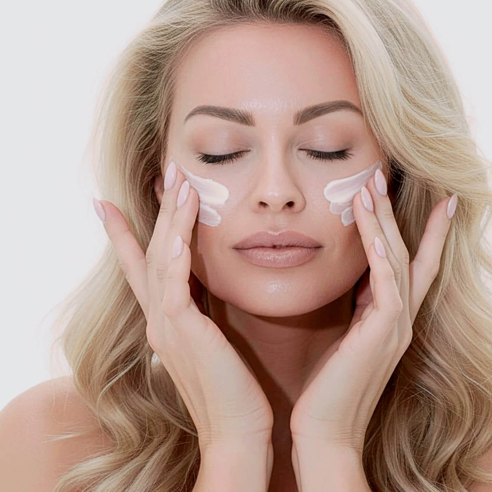 Cynthia Garcia, founder of Rewritten Beauty, applying skincare cream to her cheeks as part of a daily ritual